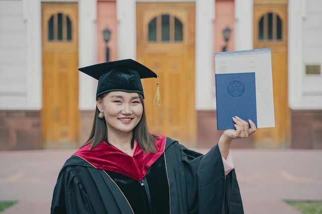 person holding her diploma